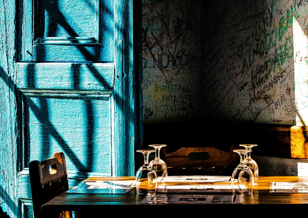 Wooden desk with old documents, magnifying glass and vintage map