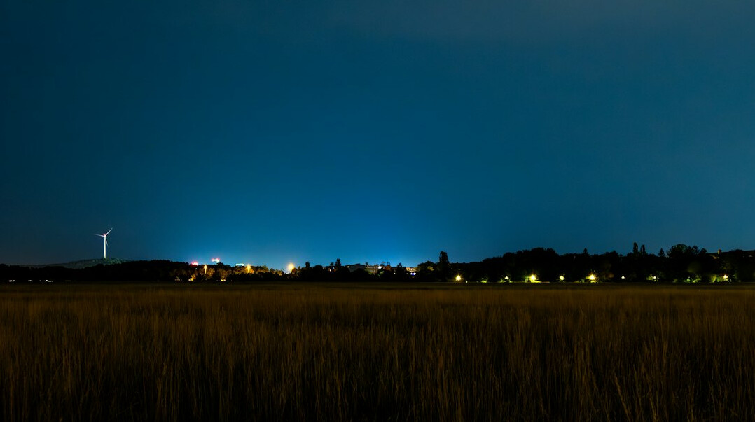 ufo flying over field at night