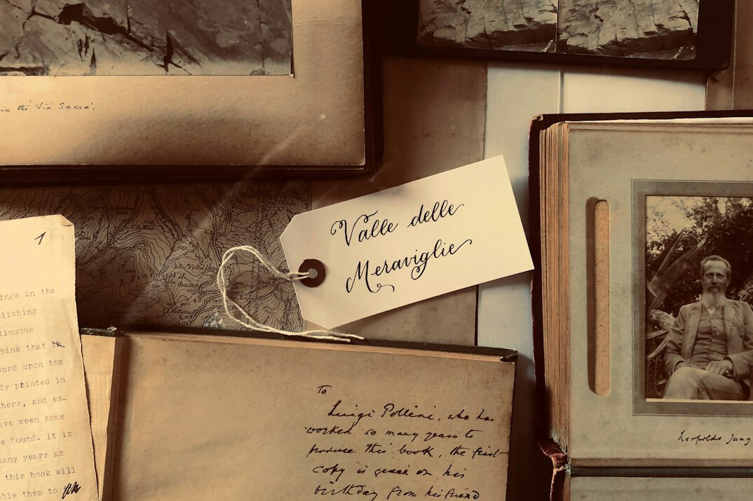 Old black and white photographs and a handwritten letter on a table